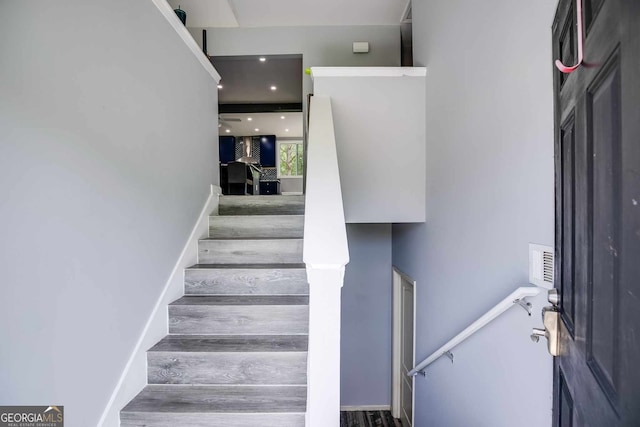 stairway featuring wood-type flooring