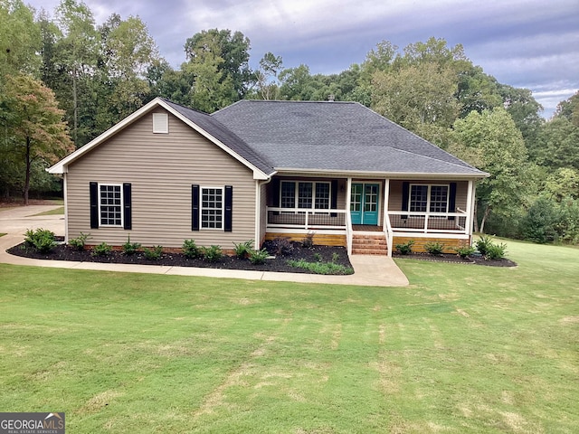 ranch-style home with a front lawn and a porch