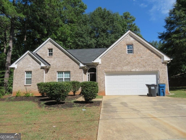 front facade with a garage and a front yard