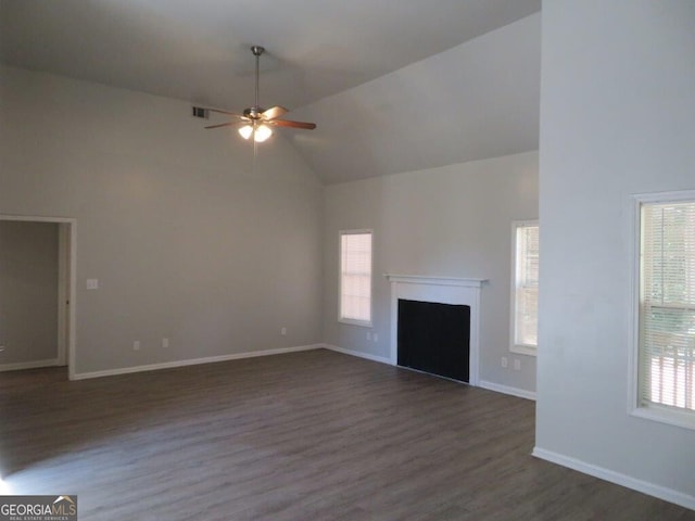 unfurnished living room with a wealth of natural light, a fireplace, and baseboards