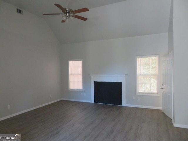 unfurnished living room with baseboards, a healthy amount of sunlight, wood finished floors, and a fireplace