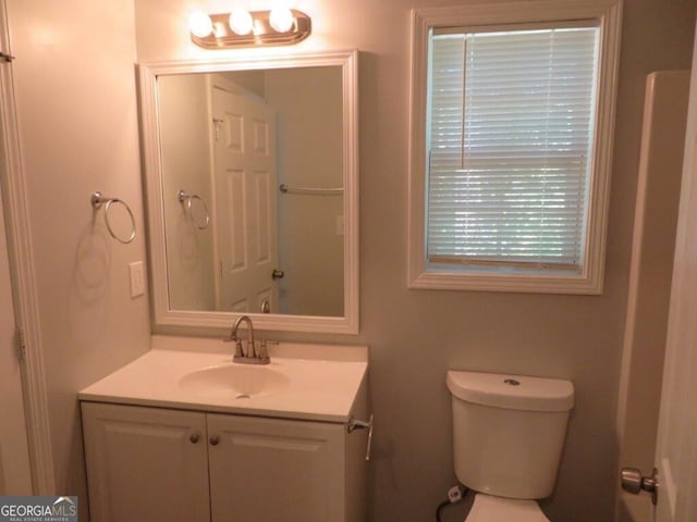 bathroom featuring toilet and vanity