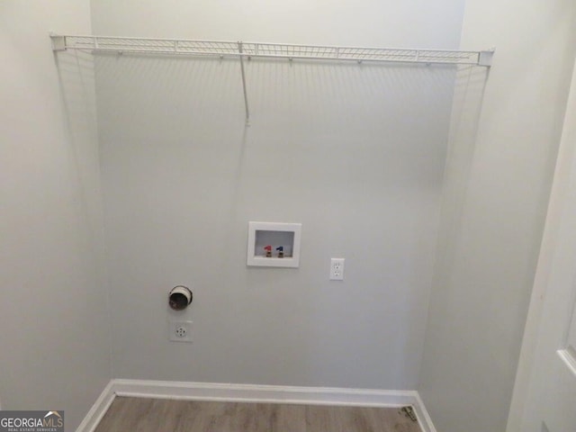 clothes washing area with electric dryer hookup, wood finished floors, hookup for a washing machine, and laundry area