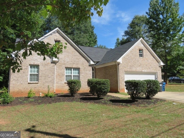 traditional-style home featuring concrete driveway, brick siding, and a front yard