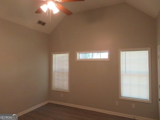 spare room featuring visible vents, lofted ceiling, baseboards, and ceiling fan