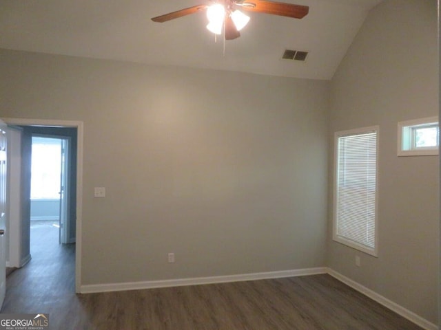 empty room featuring wood finished floors, visible vents, baseboards, lofted ceiling, and ceiling fan