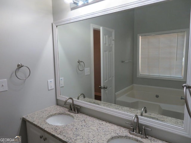 full bathroom featuring a sink, a garden tub, and double vanity