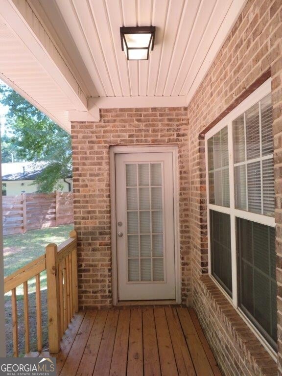 doorway to property featuring brick siding