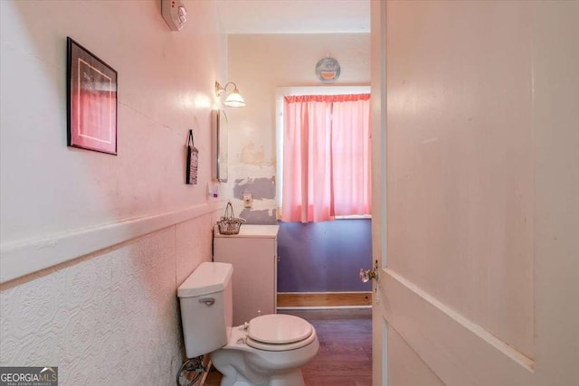 bathroom with toilet and hardwood / wood-style flooring