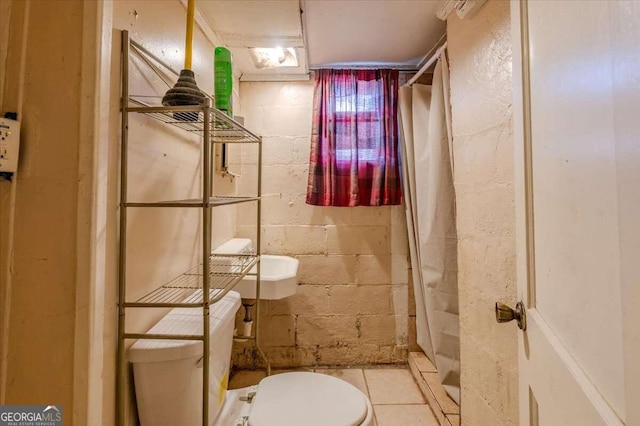 bathroom featuring a shower with shower curtain, tile patterned flooring, and toilet