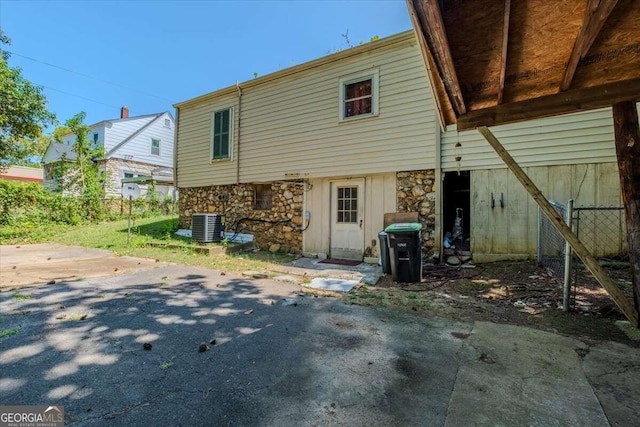 back of property featuring cooling unit