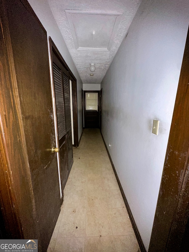 corridor featuring a textured ceiling