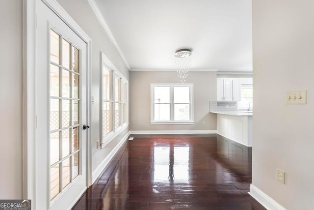 unfurnished dining area featuring ornamental molding and dark hardwood / wood-style floors