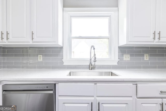 kitchen with dishwasher, light stone counters, sink, and white cabinets