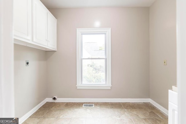 laundry area featuring cabinets and electric dryer hookup