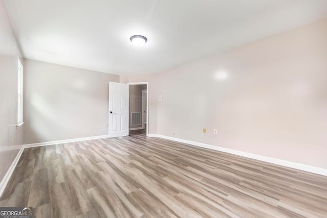 empty room featuring hardwood / wood-style flooring