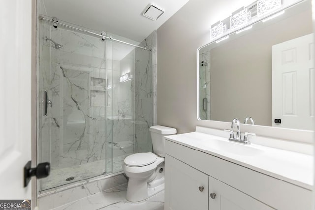 bathroom with a shower with door, vanity, and toilet