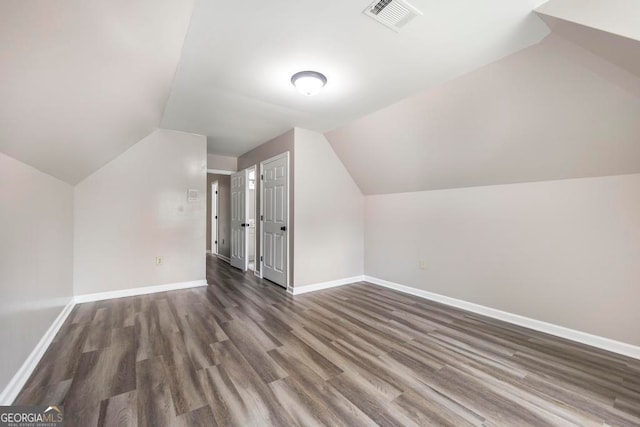 bonus room featuring dark hardwood / wood-style flooring and vaulted ceiling