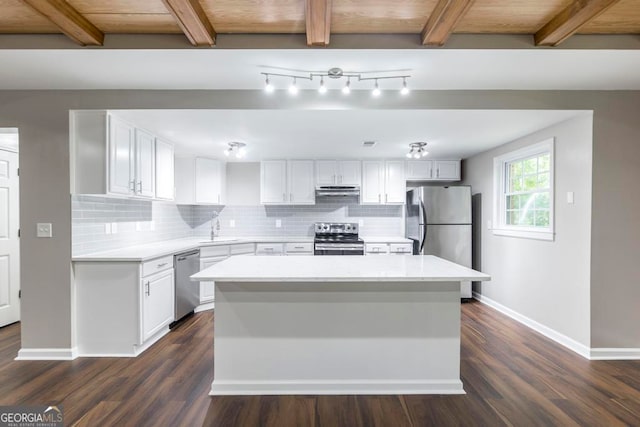 kitchen with a center island, white cabinetry, stainless steel appliances, and dark wood-type flooring