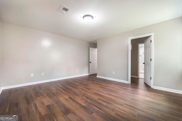 empty room featuring dark hardwood / wood-style flooring