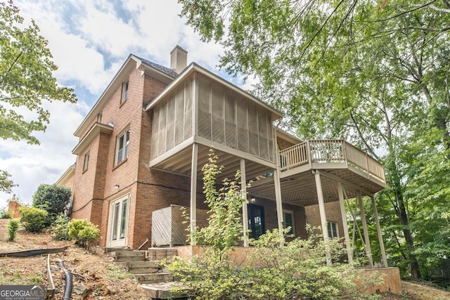 view of side of property featuring a sunroom