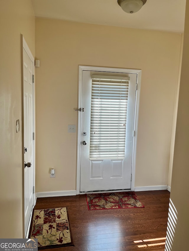 doorway with dark hardwood / wood-style flooring