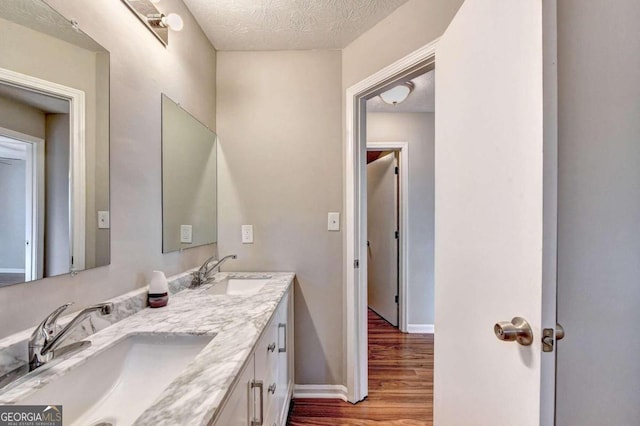 bathroom featuring vanity, a textured ceiling, and hardwood / wood-style flooring