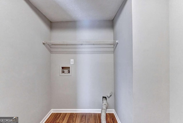 laundry room featuring washer hookup and wood-type flooring