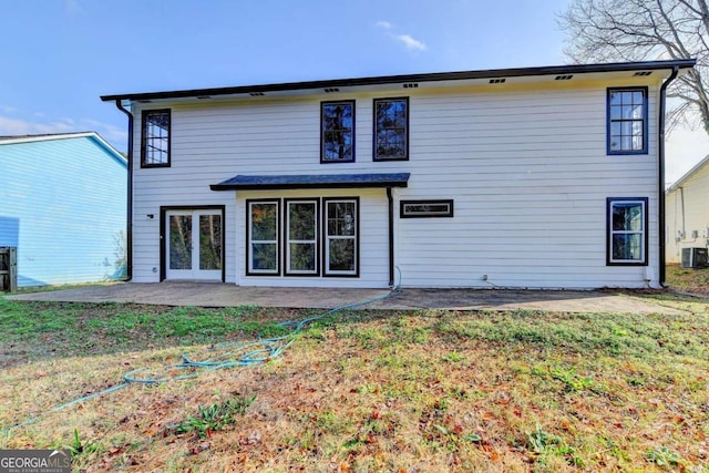 rear view of house featuring a lawn, a patio area, and central AC unit