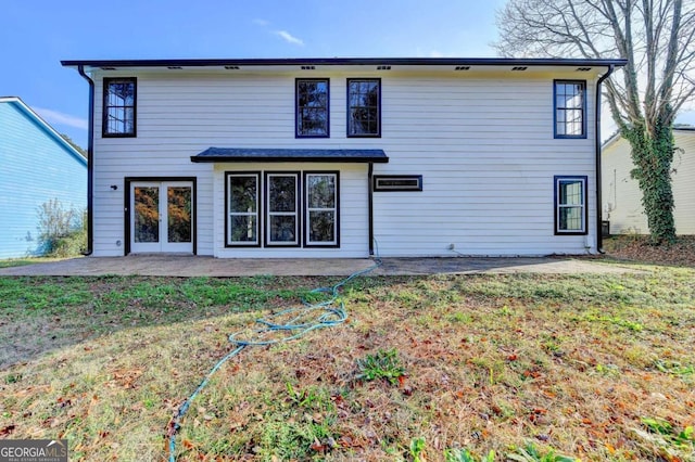 rear view of house with a yard and a patio area