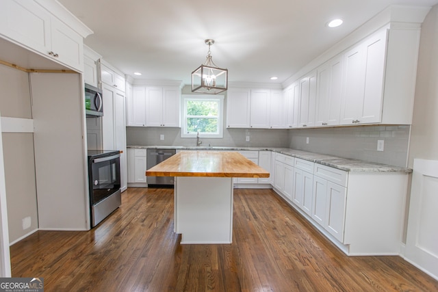 kitchen featuring a kitchen island, appliances with stainless steel finishes, dark wood-type flooring, butcher block counters, and white cabinets