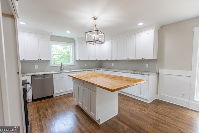 kitchen featuring dishwasher, a center island, white cabinetry, dark wood-type flooring, and butcher block counters