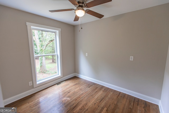 empty room featuring hardwood / wood-style flooring, plenty of natural light, and ceiling fan