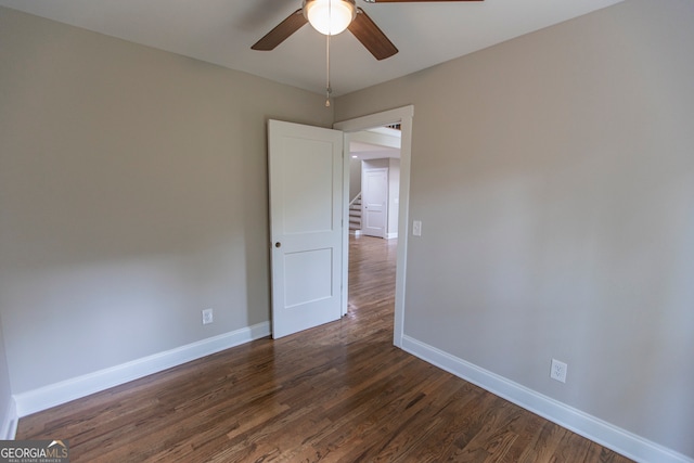 empty room featuring ceiling fan and dark hardwood / wood-style floors