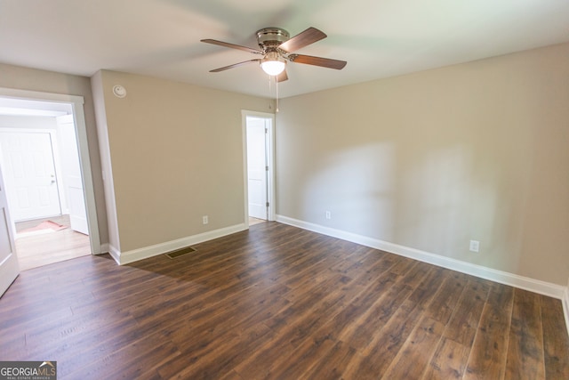 empty room with dark wood-type flooring and ceiling fan