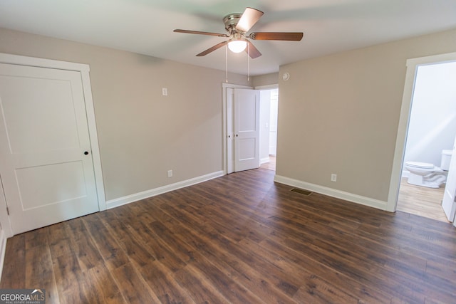 empty room with ceiling fan and dark hardwood / wood-style floors