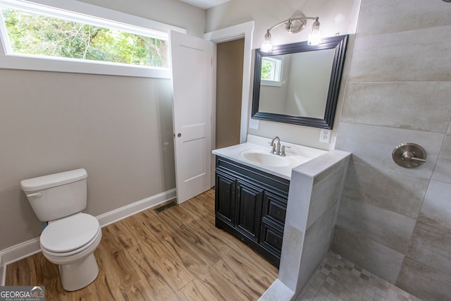 bathroom featuring vanity, hardwood / wood-style flooring, and a wealth of natural light