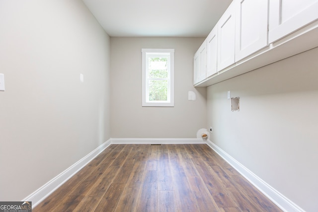 laundry area with hookup for a washing machine, cabinets, hookup for an electric dryer, and dark hardwood / wood-style flooring