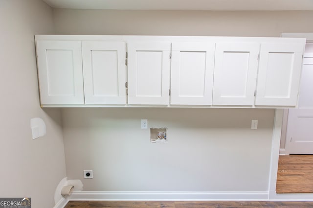 clothes washing area featuring hookup for a washing machine, wood-type flooring, cabinets, and electric dryer hookup