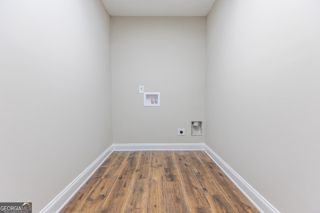 washroom with dark wood-type flooring, hookup for a washing machine, and electric dryer hookup