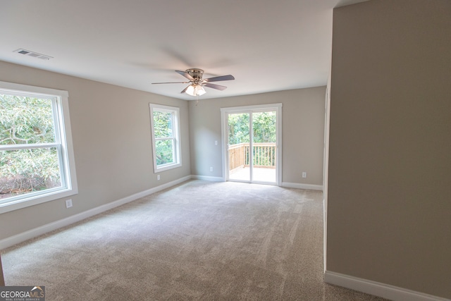 empty room with ceiling fan and carpet floors