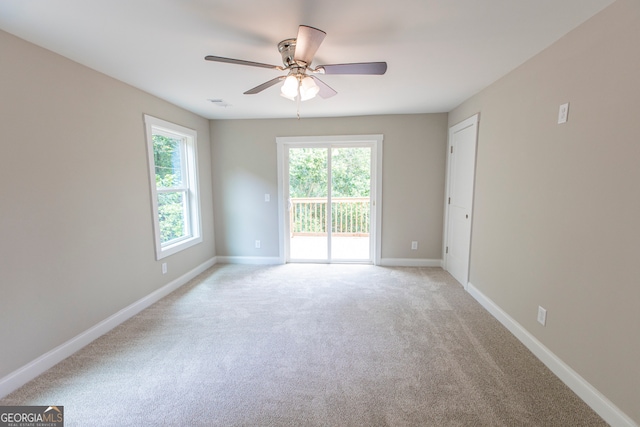 carpeted empty room featuring ceiling fan