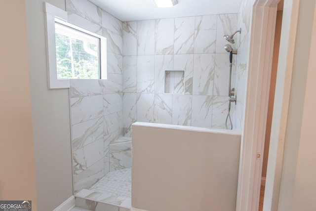 bathroom with a tile shower