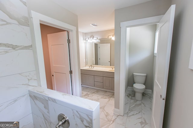 bathroom with toilet and vanity