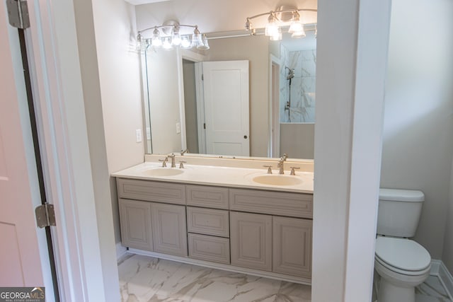 bathroom with vanity, toilet, and tiled shower