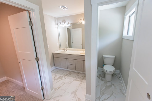 bathroom featuring vanity and toilet