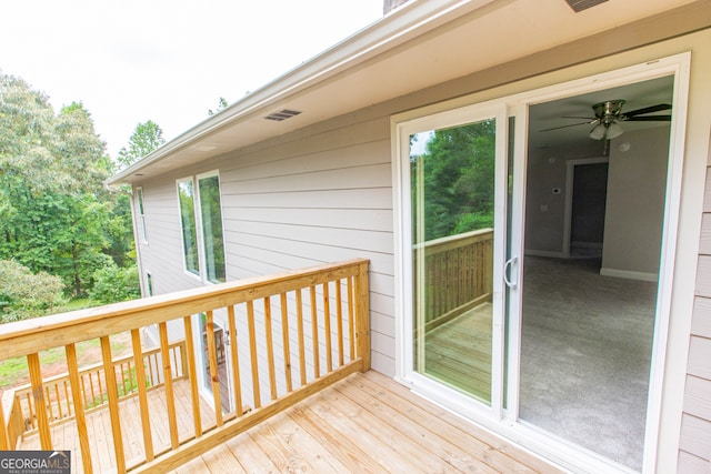 wooden deck featuring ceiling fan