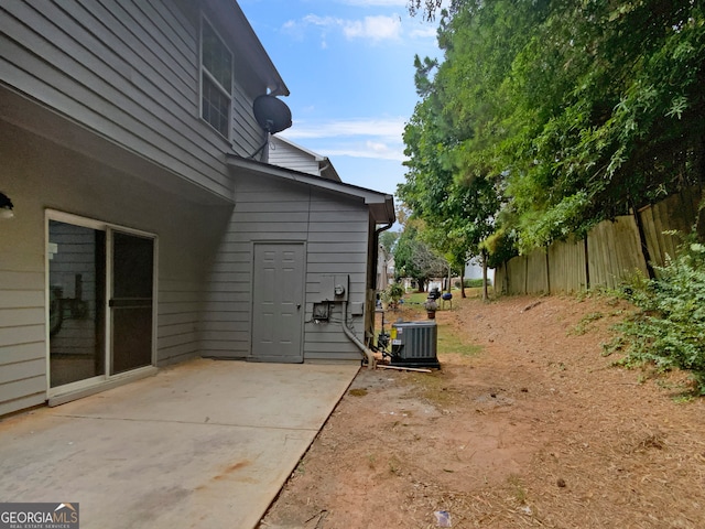 view of yard featuring cooling unit and a patio