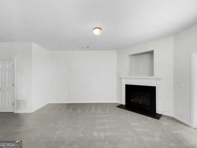 unfurnished living room featuring light carpet