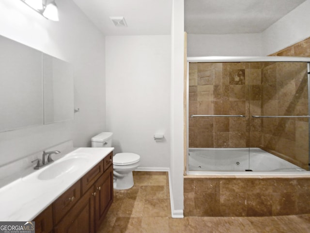 bathroom featuring toilet, vanity, visible vents, baseboards, and a combined bath / shower with jetted tub